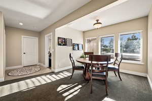 Dining area featuring carpet floors and recessed lighting
