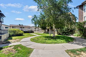 View of property's community featuring a residential view and a lawn