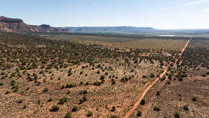 Overview of rural landscape featuring a desert landscape and a mountain backdrop