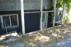 View of exterior entry with brick siding