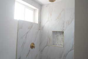 Bathroom with a marble finish shower