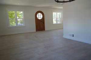Entryway with wood finished floors and baseboards