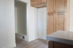 Kitchen featuring wood finished floors and baseboards