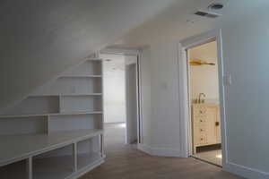 Additional living space with dark wood-type flooring and baseboards