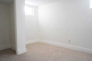 Basement featuring baseboards and carpet floors