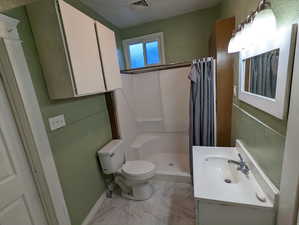 Full bath featuring vanity, marble finish floors, and a shower stall