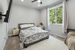 Carpeted bedroom featuring ceiling fan and recessed lighting