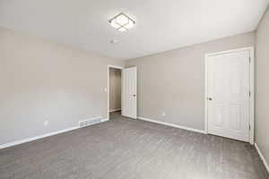 Unfurnished bedroom with baseboards and carpet flooring