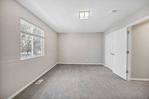 Unfurnished bedroom with carpet and baseboards