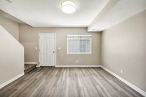 Entrance foyer featuring light wood-type flooring and a textured ceiling