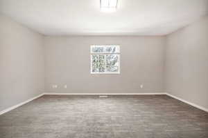 Carpeted empty room with a textured ceiling
