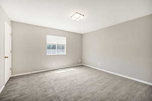 Unfurnished room featuring carpet flooring and baseboards