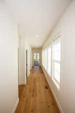 Hall featuring LVP flooring and recessed lighting