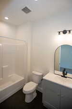Full bathroom featuring tile patterned floors, vanity,  shower combination, and recessed lighting