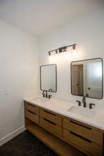 3/4 jack-and-jill bathroom with double vanity and tile patterned floors