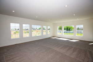 Spacious recreation/family room (lots of options) featuring recessed lighting and dark carpet with natural light