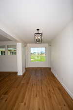 Foyer entrance featuring a chandelier and LVP flooring