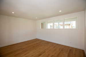 Living room featuring LVP flooring and recessed lighting