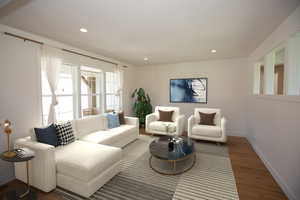 Living room featuring recessed lighting and LVP floors - Virtual Staging