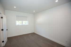 Bedroom with recessed lighting and dark colored carpet, with jack-and-jill bathroom