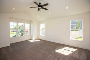 Master suite with lofted ceiling, recessed lighting, and ceiling fan