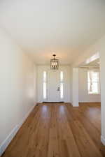 Foyer entrance featuring a chandelier and LVP flooring