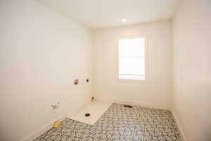 Laundry area with electric dryer hookup, washer hookup, and recessed lighting