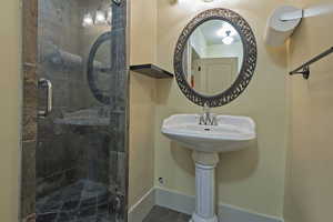 Full bathroom featuring a stall shower and tile patterned floors