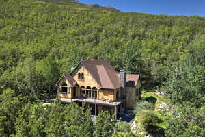View from above of property with a forest