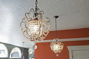 Detailed view of a chandelier and a textured ceiling