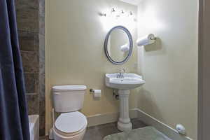 Full bath with shower / bath combo and tile patterned floors