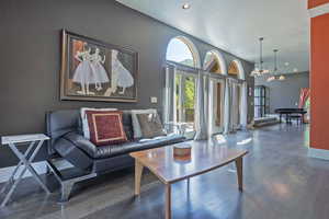 Living area with dark wood finished floors, a chandelier, recessed lighting, and a textured ceiling
