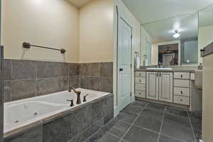 Full bath with a whirlpool tub and vanity