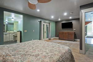 Bedroom featuring recessed lighting, light colored carpet, a textured ceiling, and ensuite bathroom