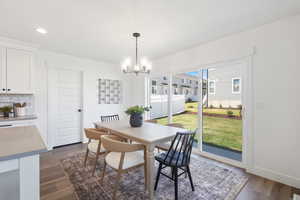 Dining area with recessed lighting, dark wood finished floors, and a chandelier