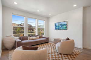 Living area with hardwood / wood-style floors and recessed lighting