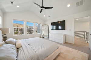Carpeted bedroom with lofted ceiling, ceiling fan, and recessed lighting