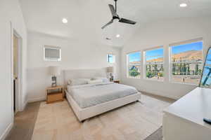 Bedroom featuring light colored carpet, recessed lighting, a ceiling fan, a mountain view, and high vaulted ceiling