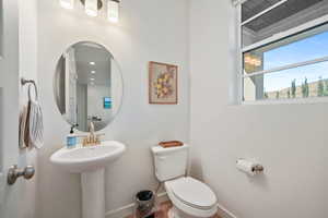 Bathroom with toilet and baseboards