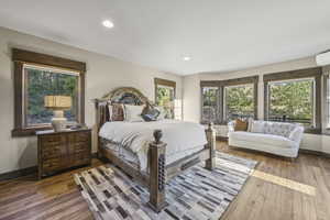 Bedroom featuring multiple windows, recessed lighting, wood finished floors, and a wall mounted AC