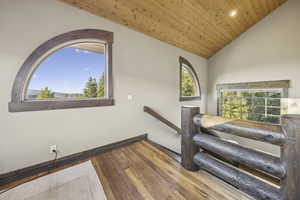Stairway featuring hardwood / wood-style flooring, lofted ceiling, wooden ceiling, and recessed lighting