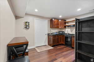 Kitchen featuring open shelves, dark countertops, dark wood finished floors, recessed lighting, and black appliances