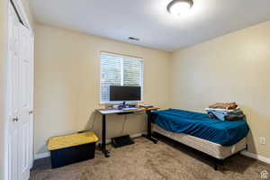 Bedroom featuring carpet floors and baseboards