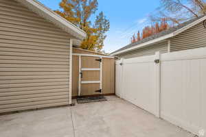 Doorway to property featuring a gate and a patio area