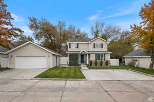 Traditional-style home with an outbuilding, a garage, and a gate