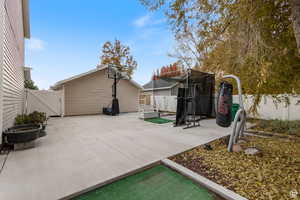 Fenced backyard with a gate and a patio area