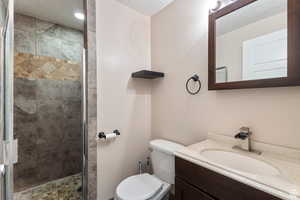 Bathroom featuring a shower stall, vanity, and a textured ceiling