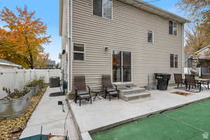 Rear view of house with a patio and an outdoor fire pit