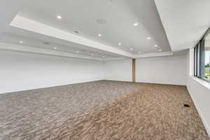 Basement featuring dark carpet and recessed lighting