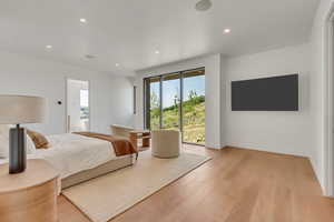 Bedroom with light wood-type flooring, recessed lighting, and access to outside
